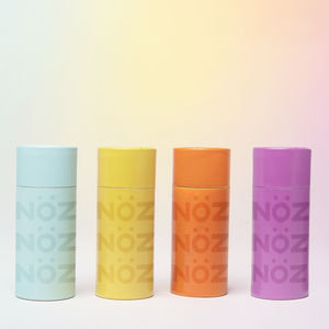 Four variety colors of NOZ sunscreen; Bold Bloo, YOLO Yell-o, Oh My Orange, Purrfect Purple